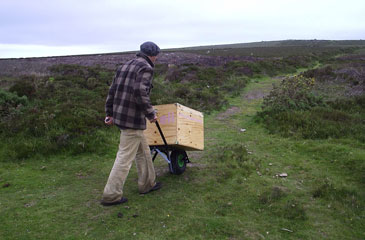 Peter Bodenham pushing the Eli cart over rough ground